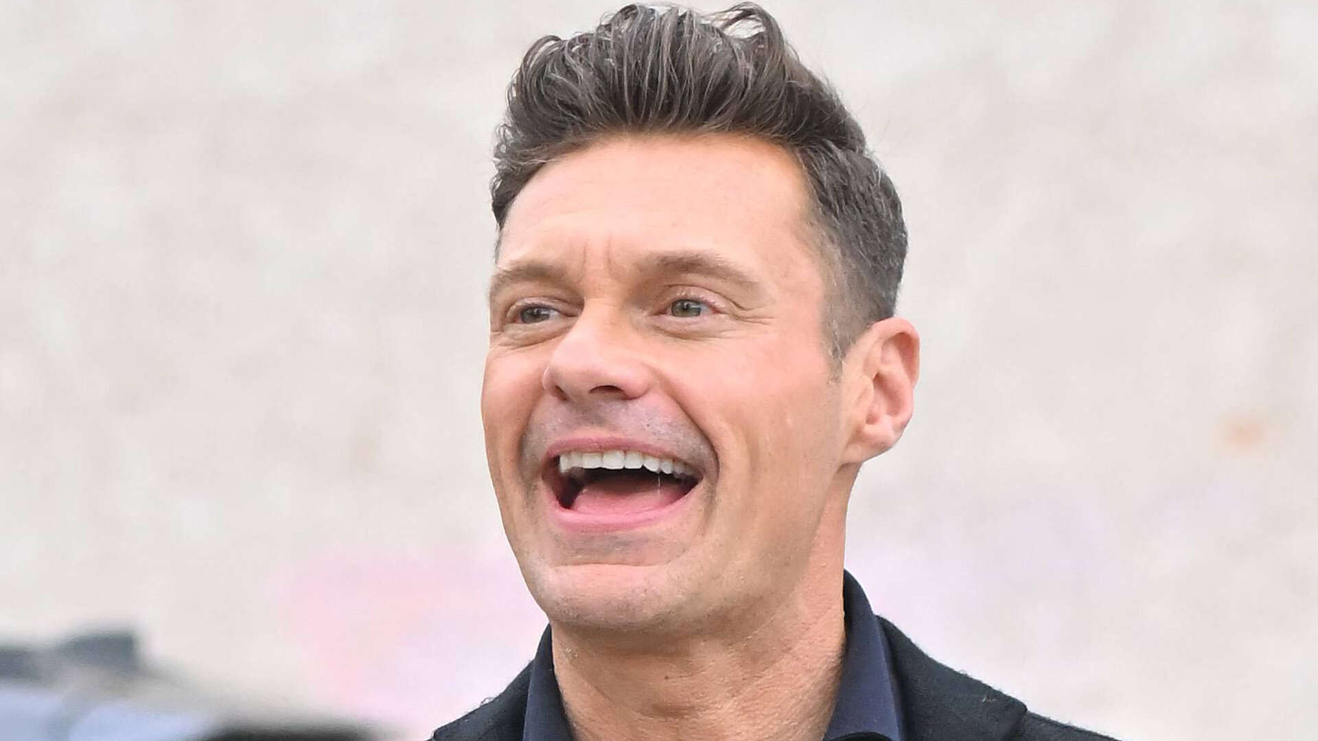 Ryan Seacrest looks ecstatic as he throws his hands up in the air on LA outing after split from girlfriend Aubrey Paige