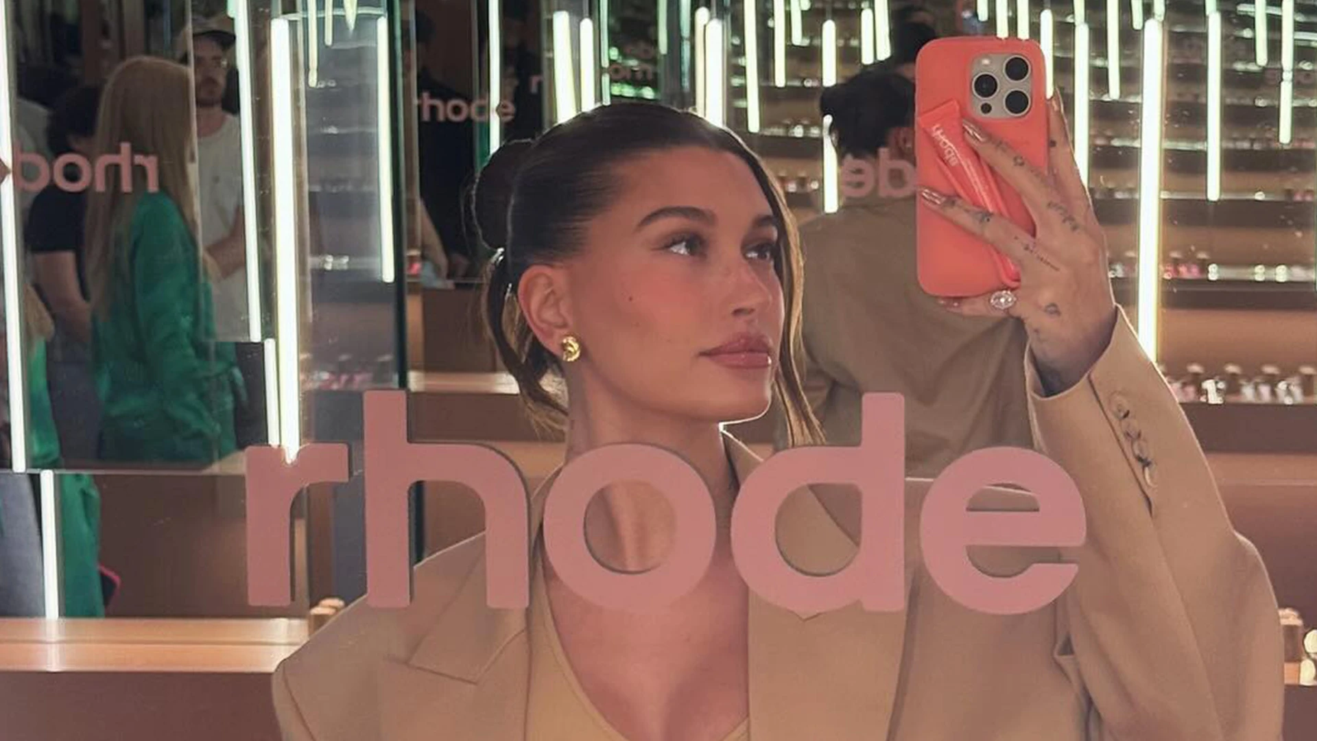 Hailey Bieber’s growing baby bump seen in tight dress at Rhode pop-up shop as Kylie Jenner praises pregnant star