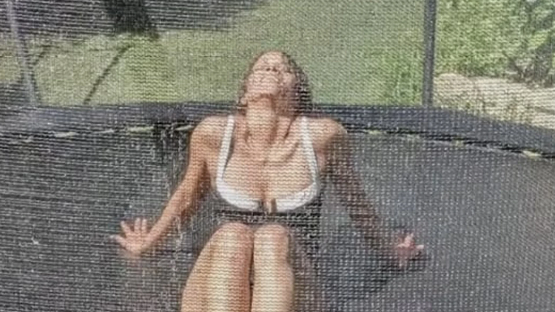 Halle Berry, 58, bounces on trampoline in just a cheeky swimsuit as she’s sprayed with a hose