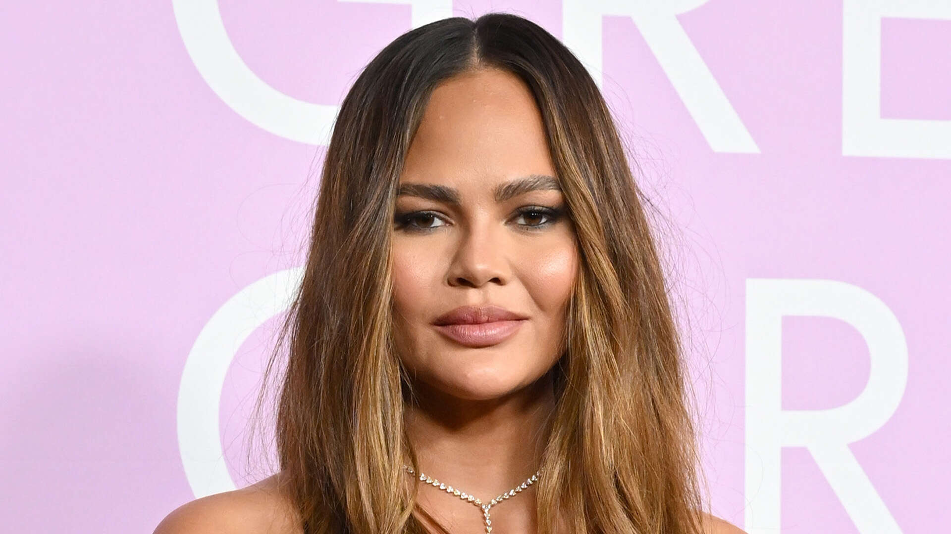 Chrissy Teigen leaves little to the imagination as she poses topless and flaunts her toned figure in video taken at home