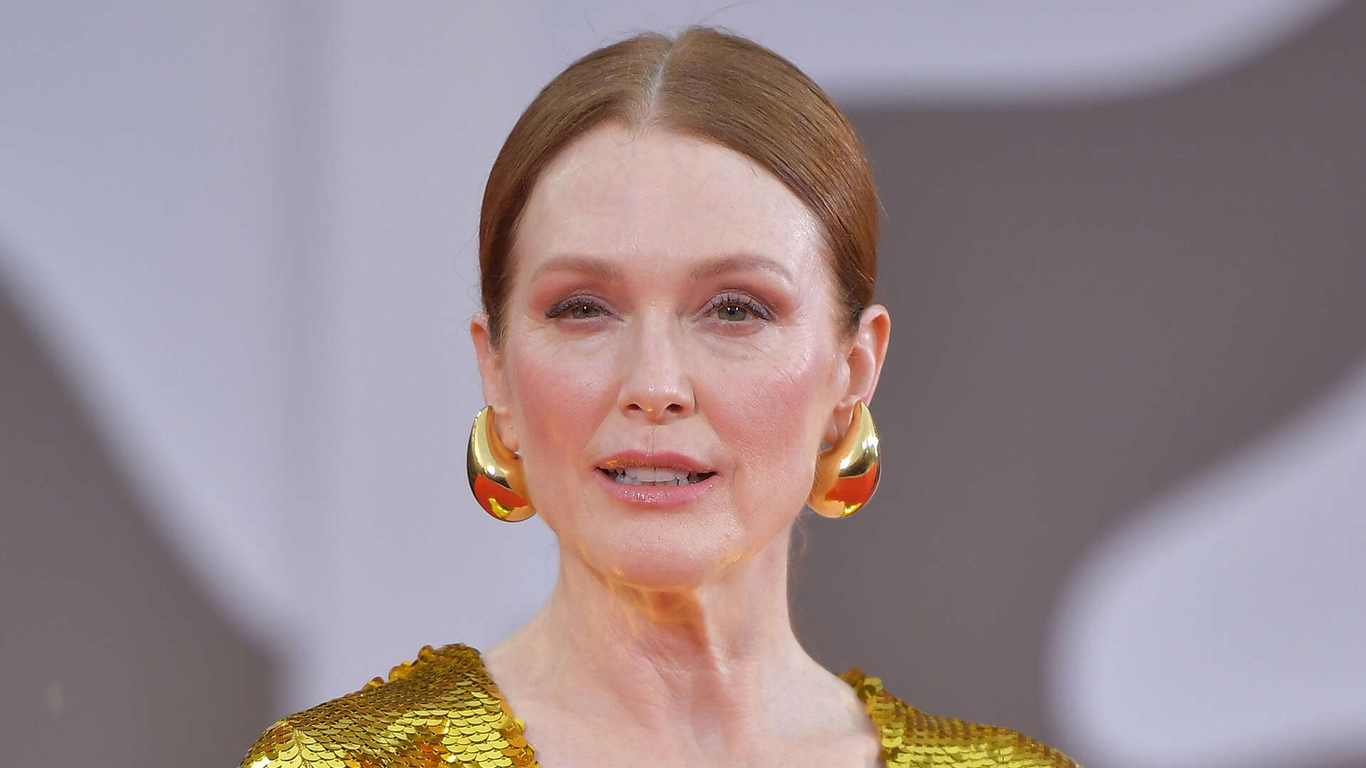 Julianne Moore, 63, shines in golden plunging gown at The Room Next Door premiere as film gets 17 minute ovation