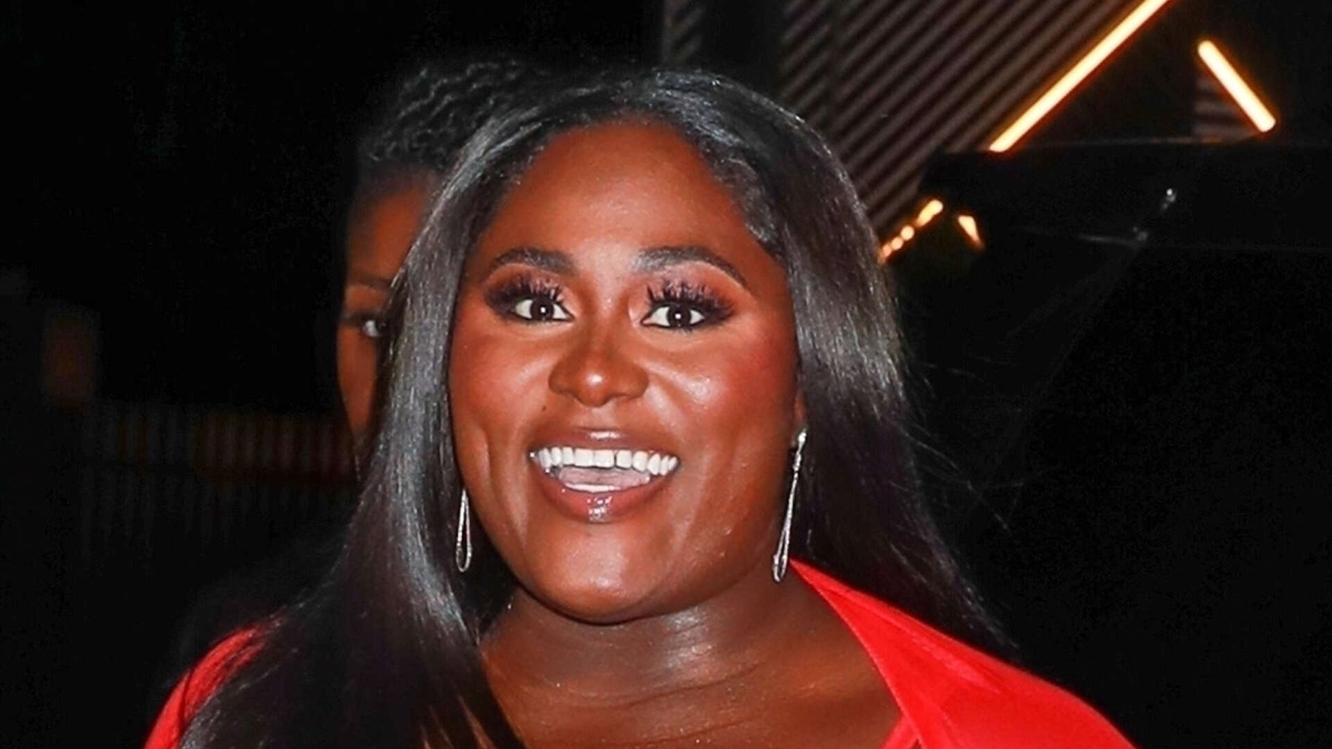 The Color Purple’s Danielle Brooks shows off her curves in skintight plunging red dress at LA bash ahead of Oscars