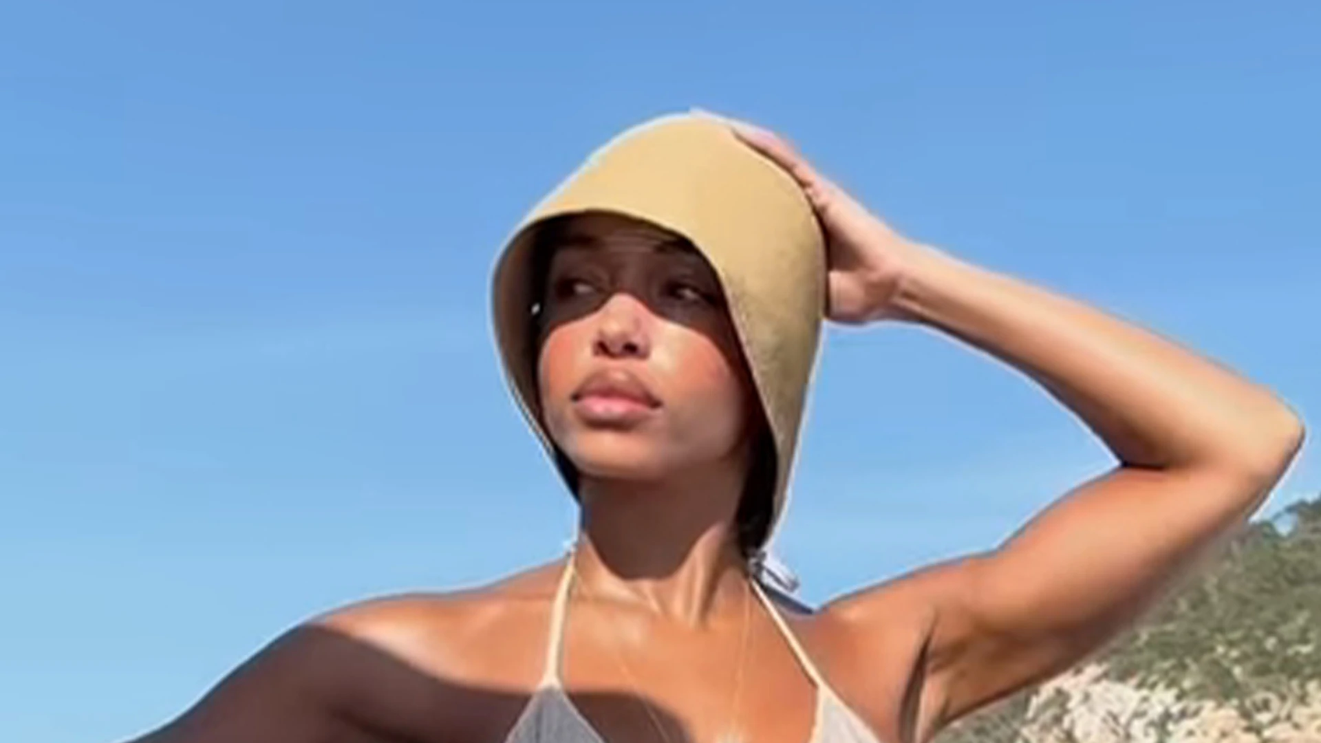 Lori Harvey reveals her six-pack abs in a shimmering gold bikini on boat ride as she declares ‘summer is here’