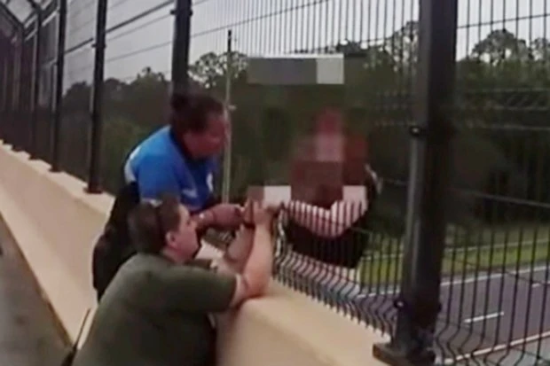 Heartstopping moment cop saves suicidal girl from jumping off overpass