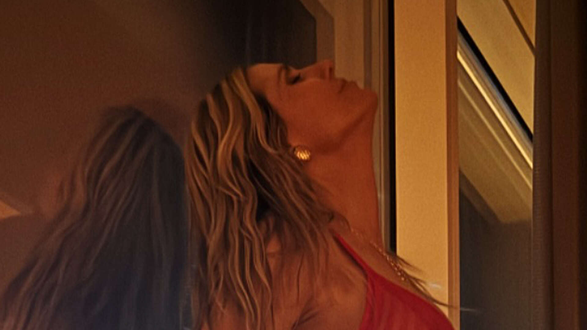 Heidi Klum rocks just see-through red lingerie as she stands against Las Vegas hotel window in post-date night photo