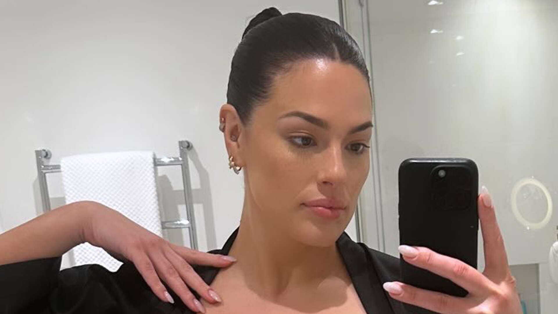 Ashley Graham teases her black lingerie bodysuit under silk robe as she prepares for appearance at Dolce & Gabbana show