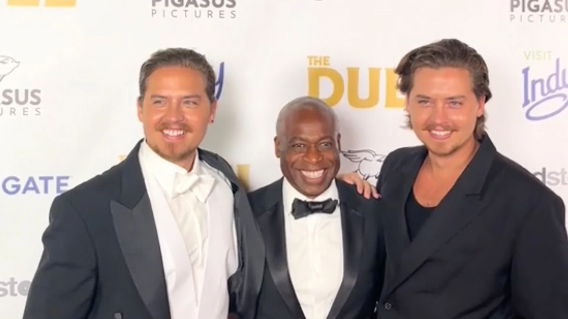 Dylan and Cole Sprouse reunite with Suite Life co-star Phill Lewis at The Duel premiere as fans gush ‘this is iconic’