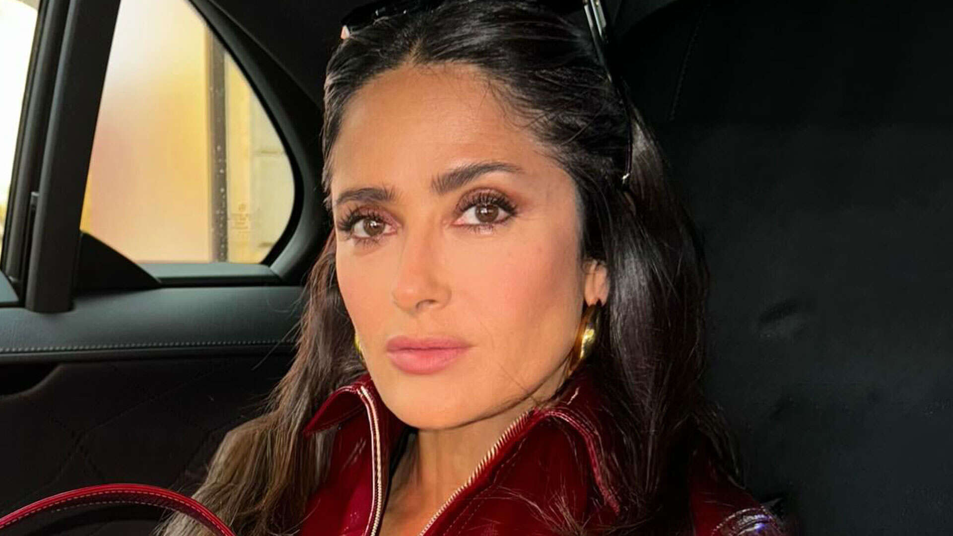 Salma Hayek, 57, flaunts her curves in leather jacket while in traffic in Milan – admits she almost missed fashion show