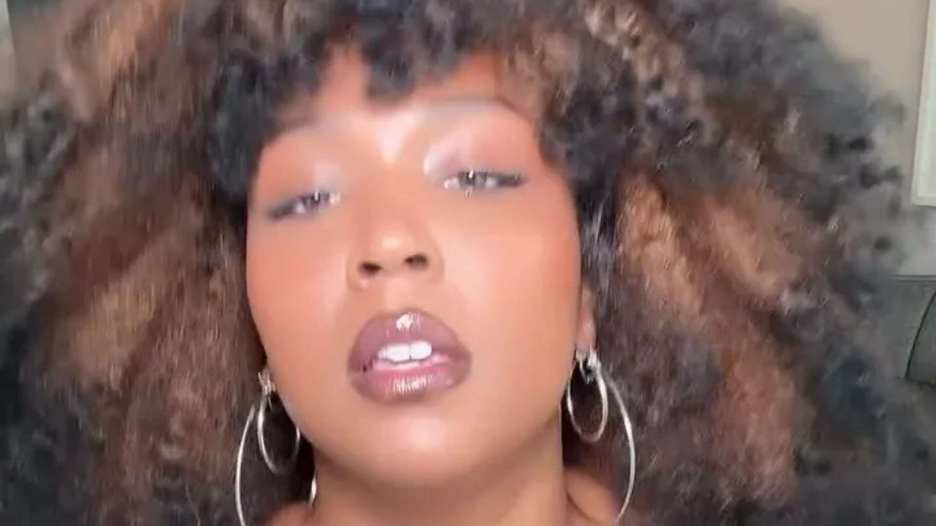 Lizzo wows fans as she strips down to busty black dress as star showcases dramatic weight loss