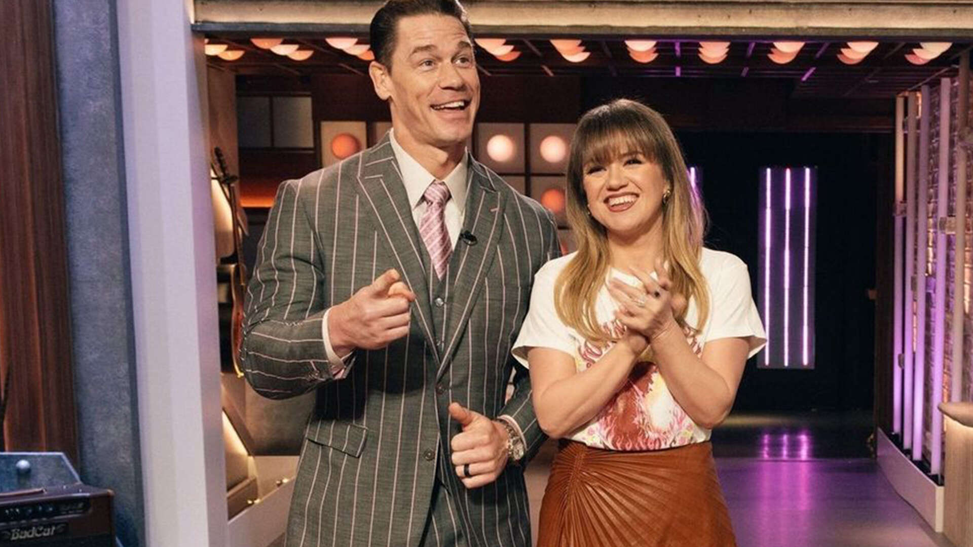 Kelly Clarkson cozies up to hunky action star on set of her show as fans admit surprise that he’s ‘wearing clothes’