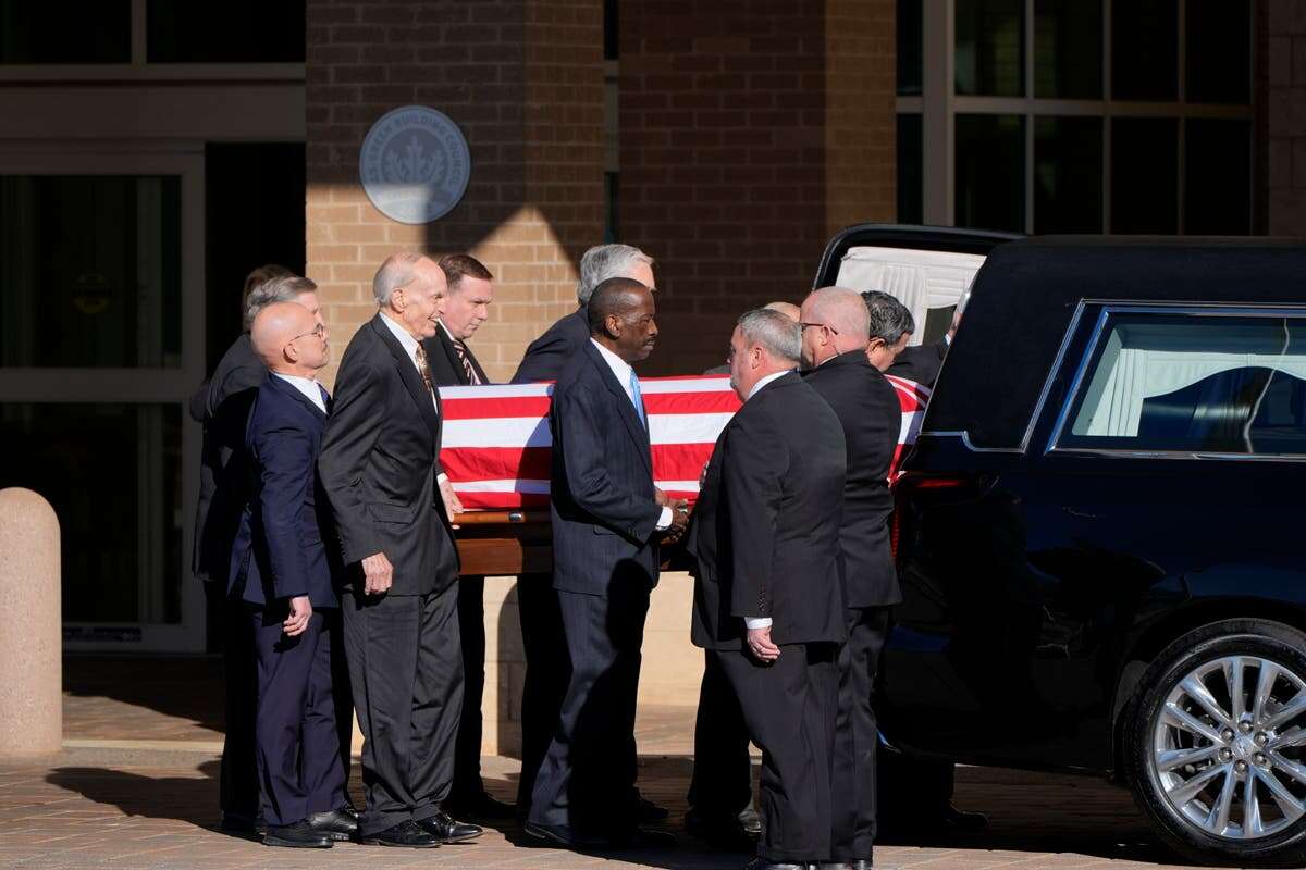 Carter’s casket carried by Secret Service agents as procession begins