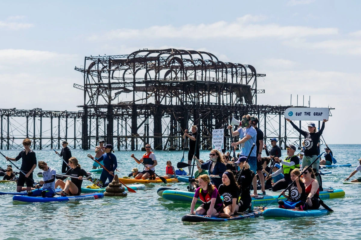 Thousands turn out for paddle out protests over ‘sewage scandal’