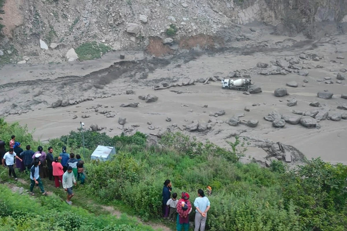 Floods sweep away 18 people and bridge linking Nepal to China