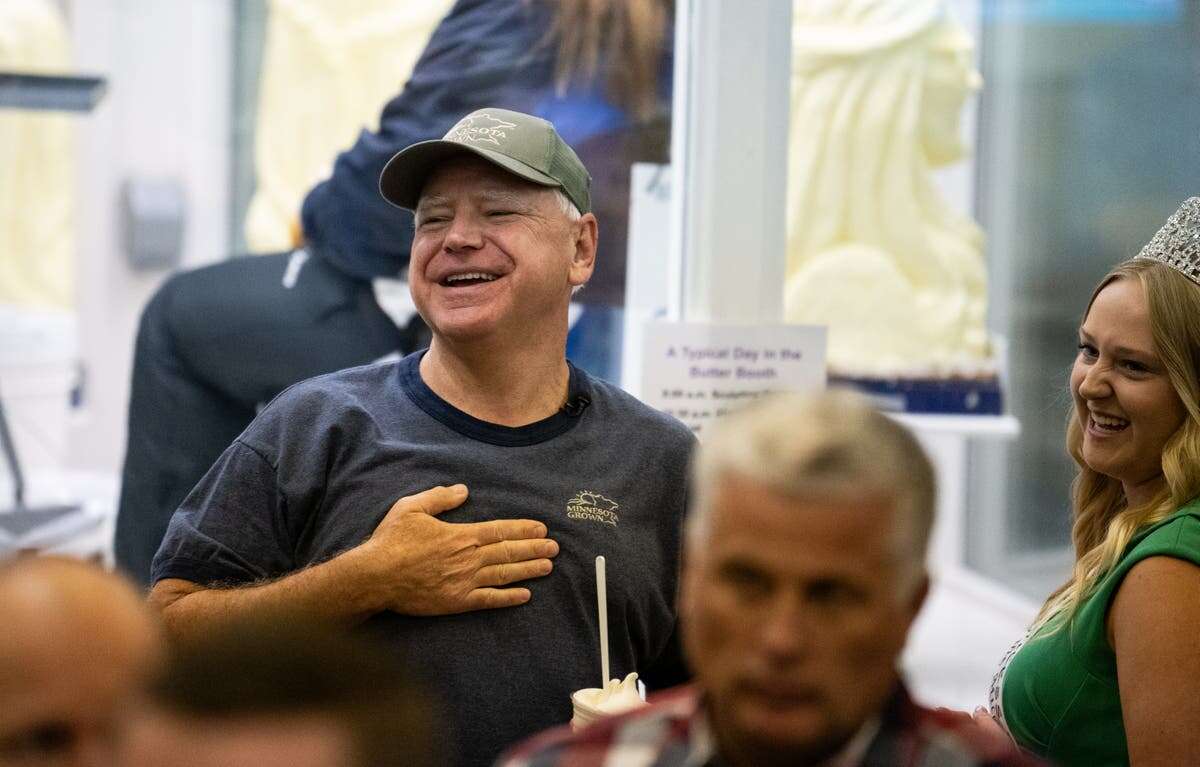 Tim Walz aims donut jibe at JD Vance on visit to farmers’ market