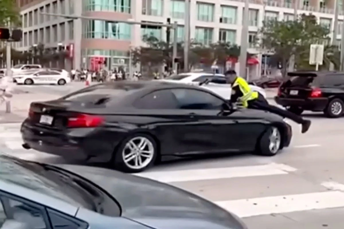 Shocking video shows cop on the hood of a moving car before shooting