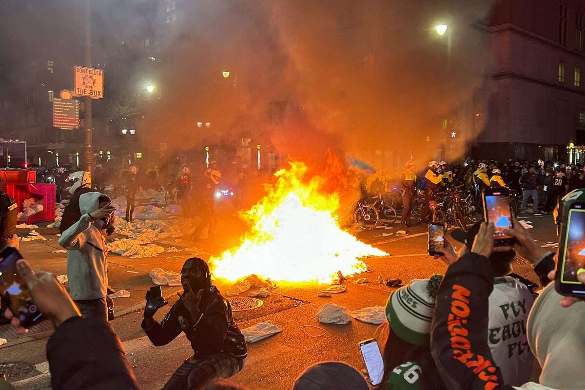 Chaos on Philadelphia streets as fans set fires and climb on cop cars