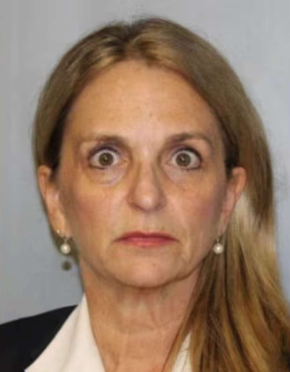 Georgia prosecutor accused of theft is stunned in her police mugshot