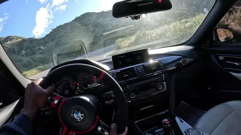 BMW M3 Narrowly Dodges Crowd Standing In Middle Of Canyon Road