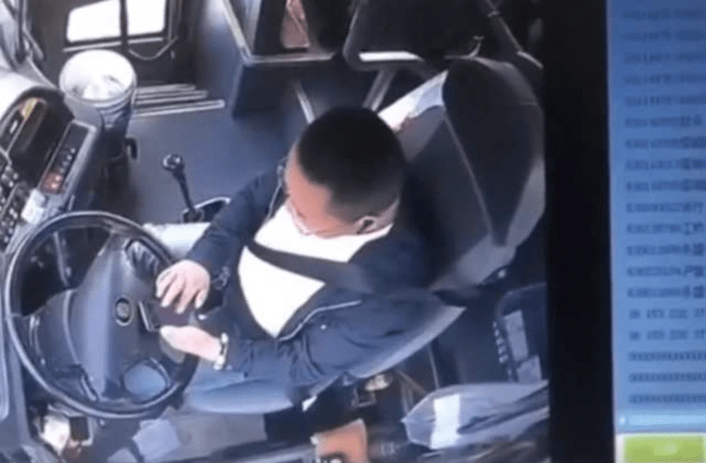 Bus carrying passengers rear-ends truck on Chinese highway as driver plays on phone while driving
