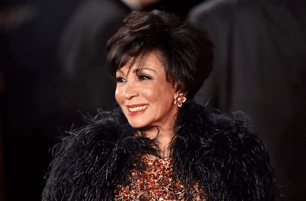 Dame Shirley Bassey poses in sequined gold face mask ahead of new album
