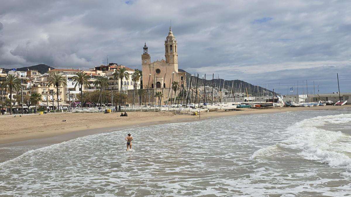 Bañistas en Sitges pese a la mala mar