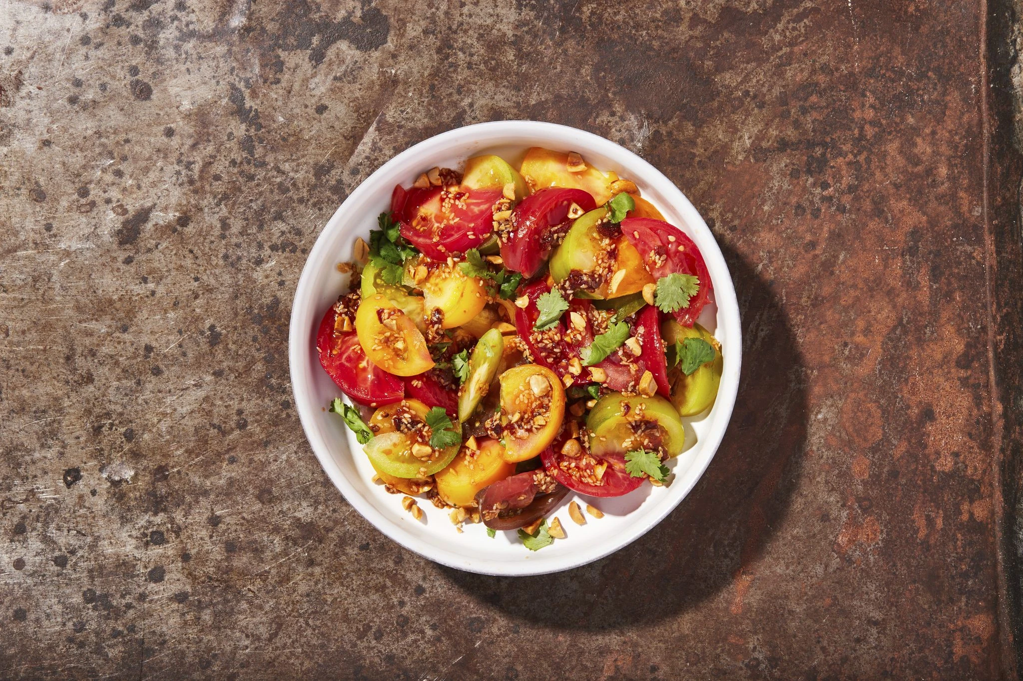 Savory-spicy peanut dressing complements the sweetness of this tomato salad