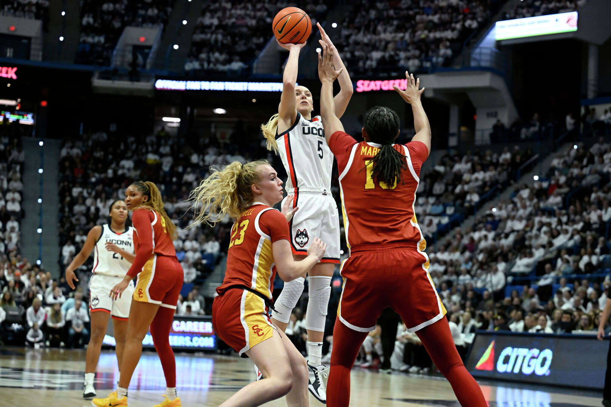 UConn wearing Nike shoes with slogan from Sue Bird's company