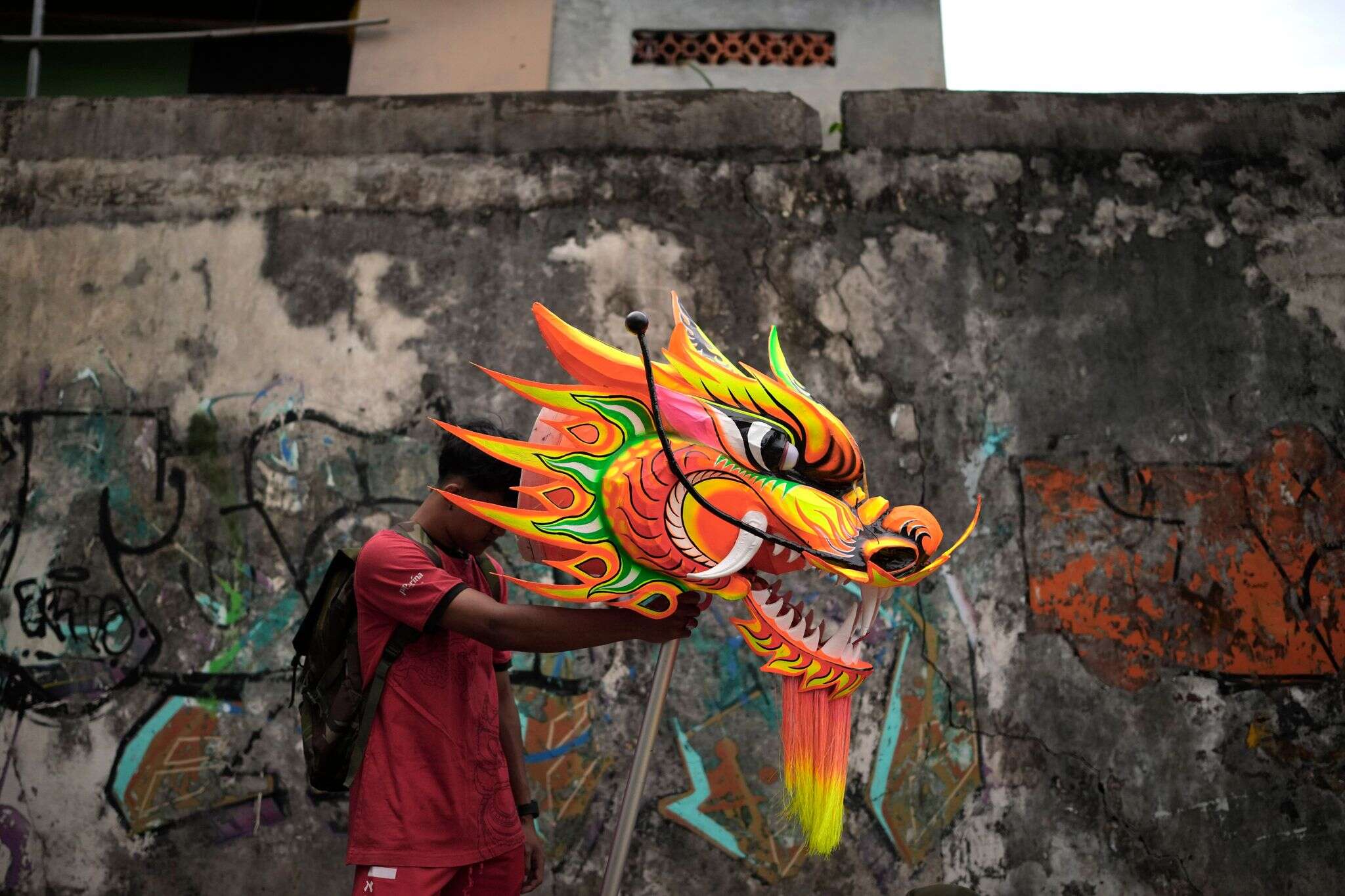 AP PHOTOS: Indonesia welcomes the Year of the Snake with dragon puppets and drum displays