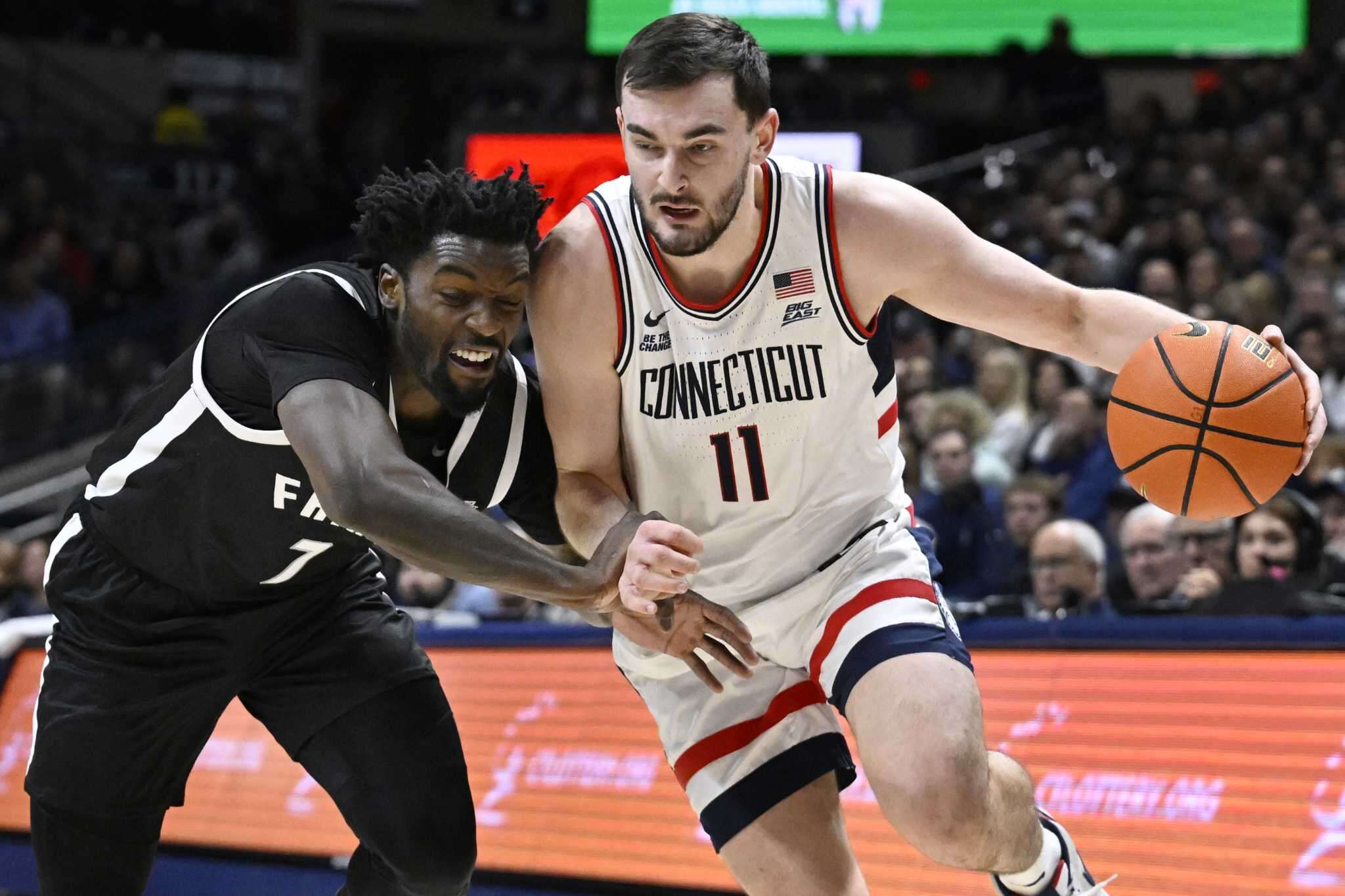 No. 11 UConn erases a 14-point deficit to top Providence 87-84 and stay unbeaten in the Big East