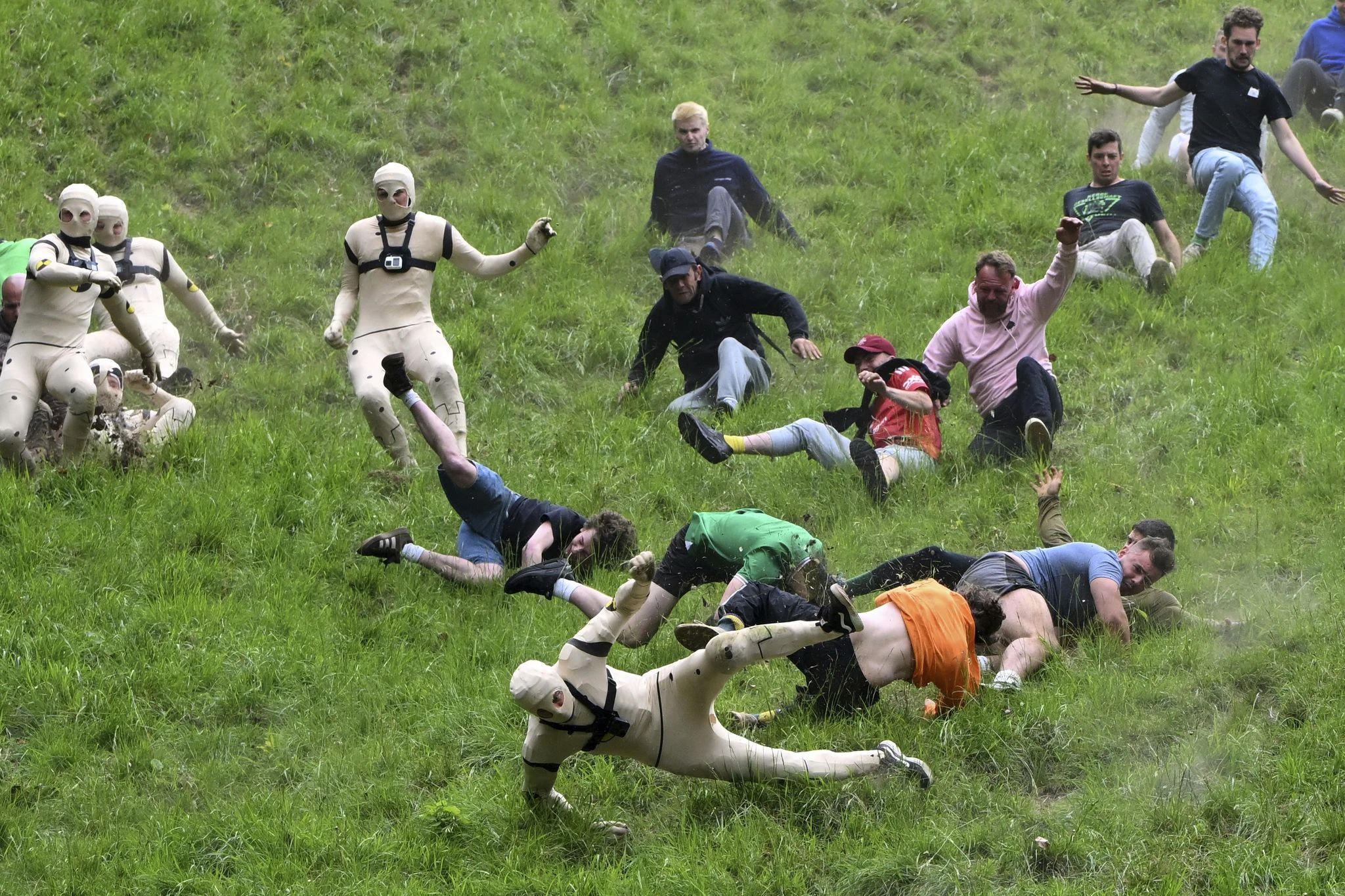 AP PHOTOS: Runners trip, stumble and roll their way to victory in annual downhill cheese chase