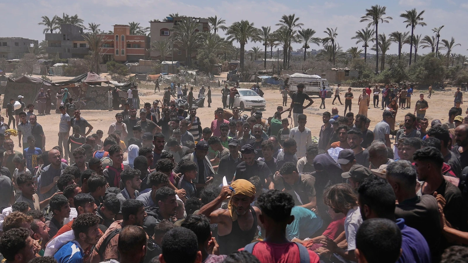 Photos show Palestinians pursuing food aid after the latest air drops in Gaza