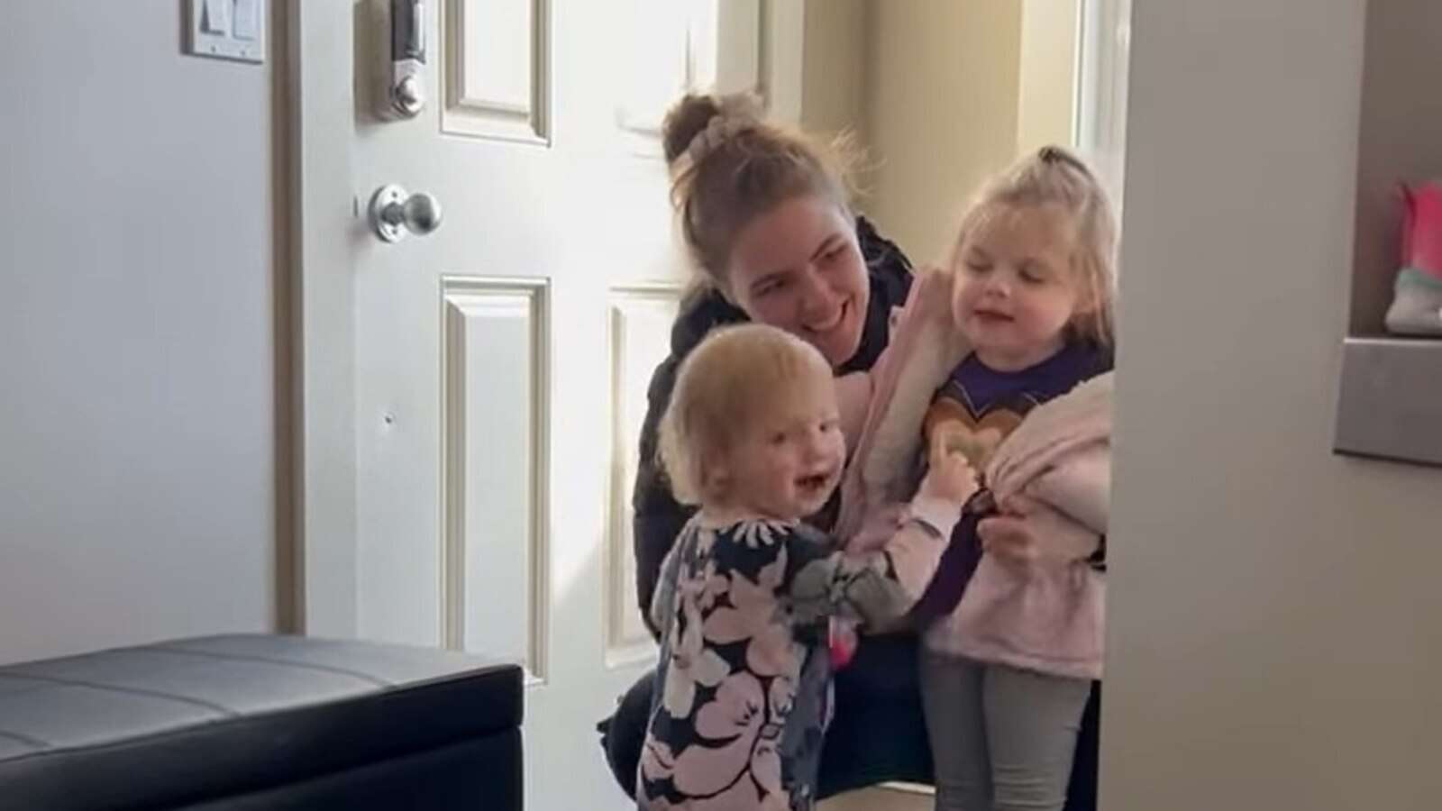 Toddler excitedly welcomes big sister home from preschool