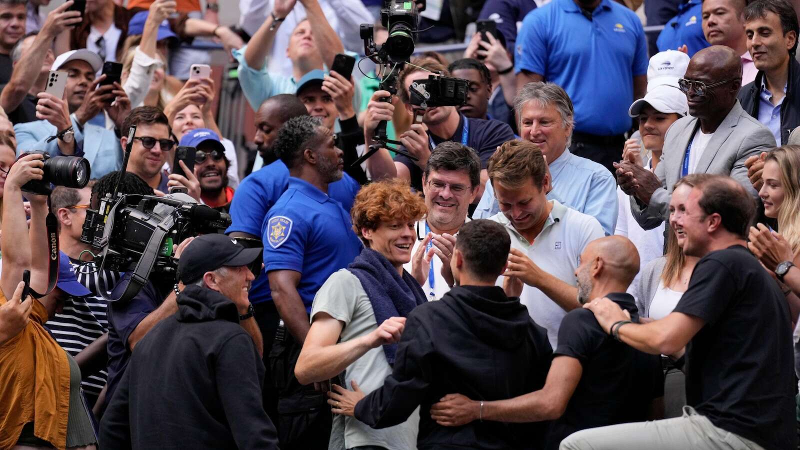 Jannik Sinner gets a hug from his friend Seal after winning the US Open title