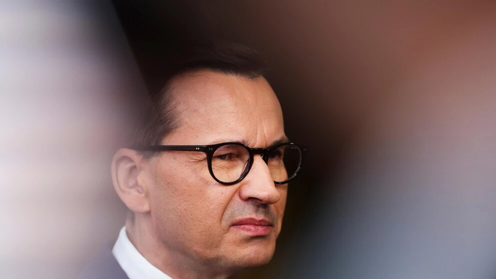 A day of 2 prime ministers in Poland begins the delayed transition to a centrist, pro-EU government