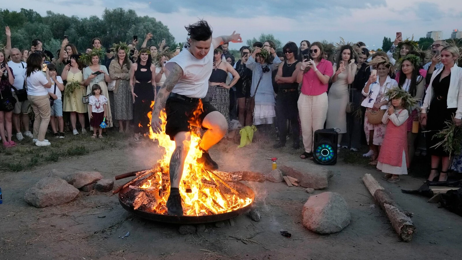 Ukrainians in Warsaw jump over a bonfire, float braids to celebrate solstice custom away from home
