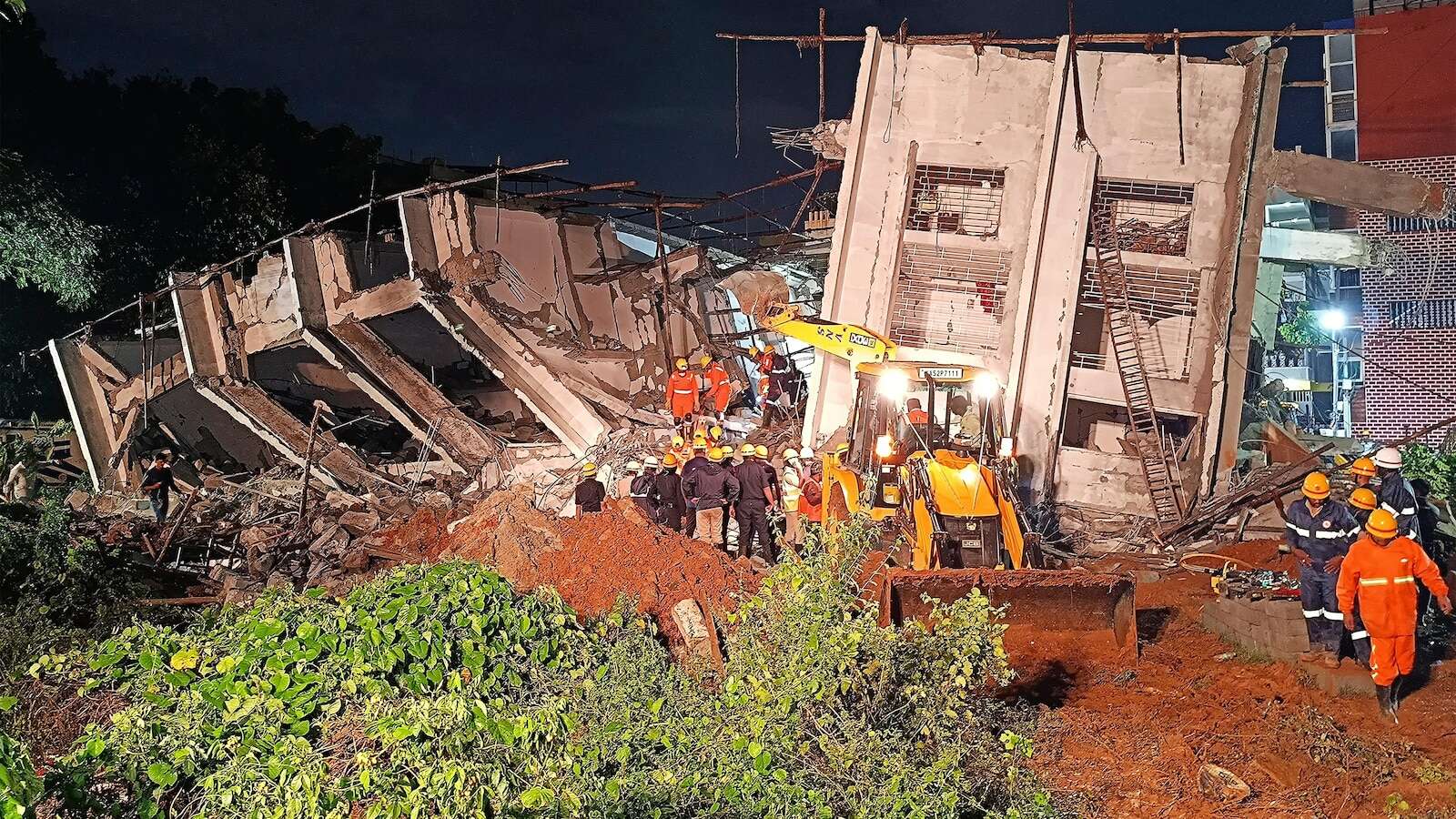 Building collapses during heavy rains in southern India city, killing at least 5 workers