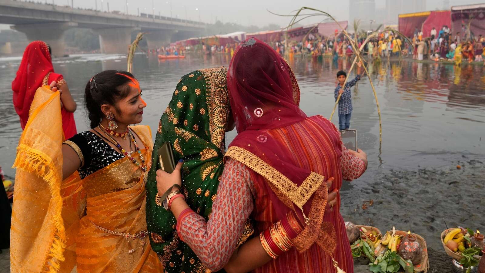 AP PHOTOS: Tens of thousands of Hindu devotees flock to rivers for prayers to the sun god