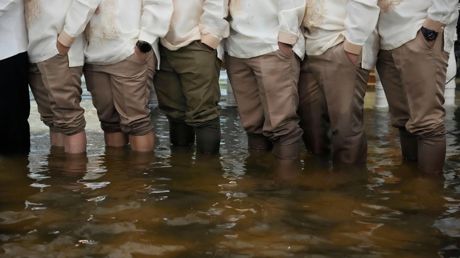 Photos show a Filipino couple walking down a flooded aisle on their wedding day