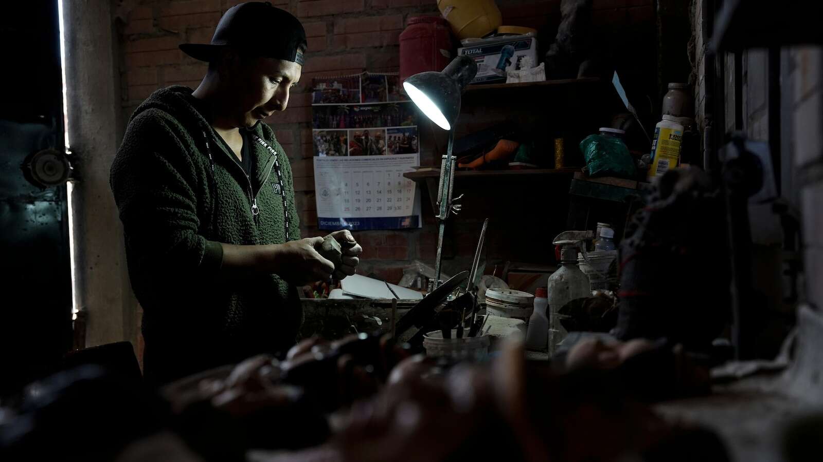 A Bolivian artist carves faces of the departed onto Day of the Dead bread