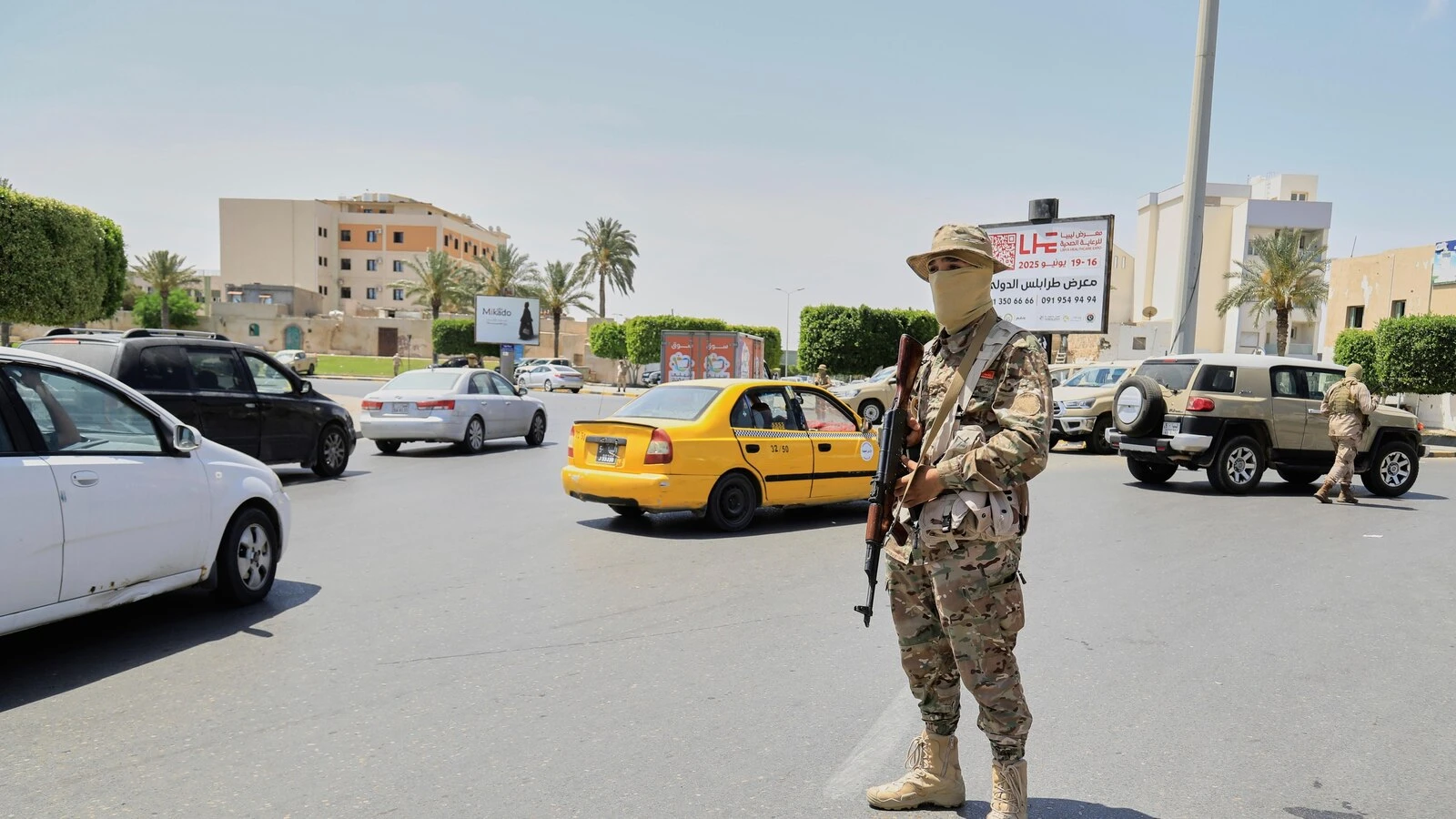 A warlord and 6 other people killed as militia infighting rocks Libya's capital, officials say