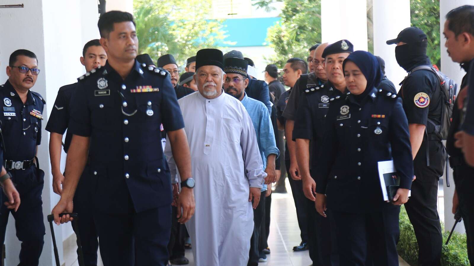 Malaysia charges 22 members of an Islamic business group, including its CEO, for organized crime