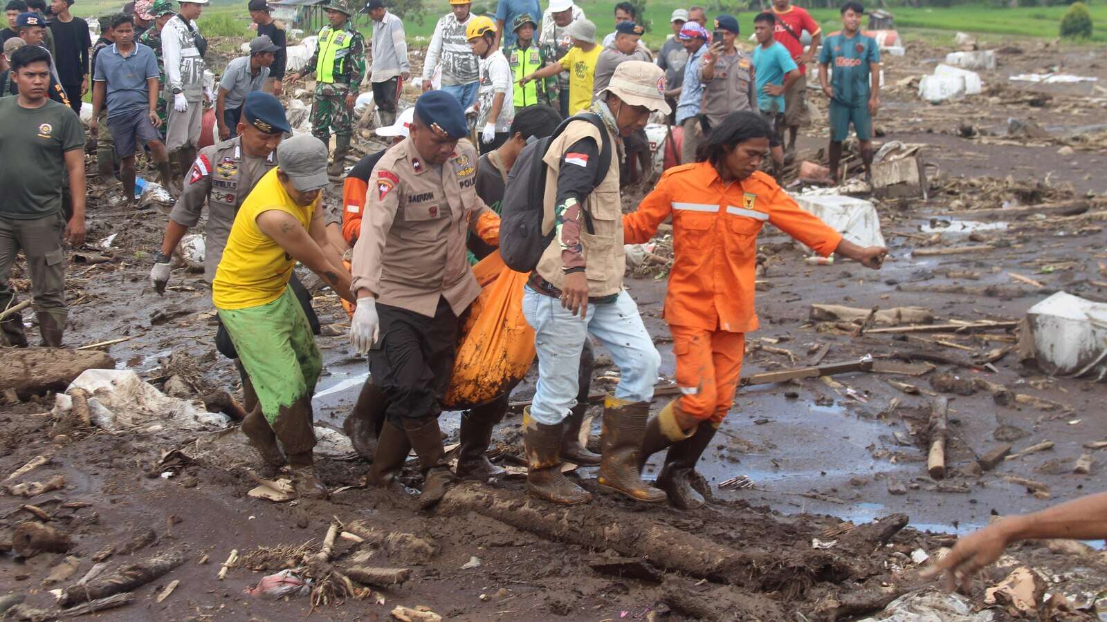 Indonesian rescuers search through rivers and rubble after flash floods that killed at least 50