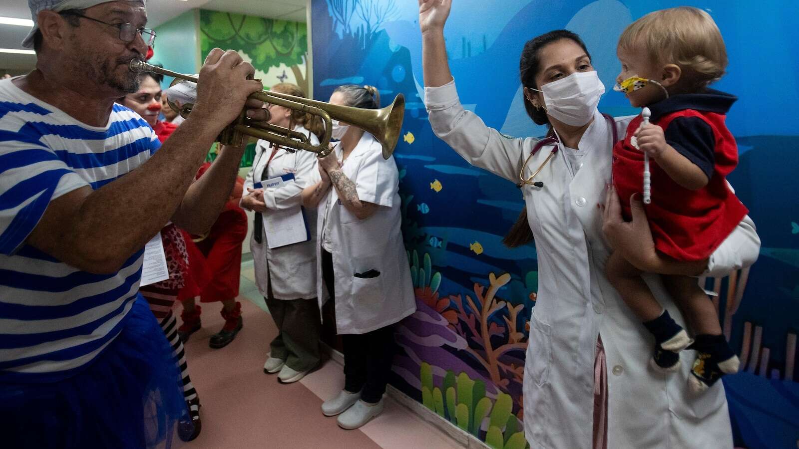 Clowns and musicians bring the joy of Carnival to sick children in a Rio hospital