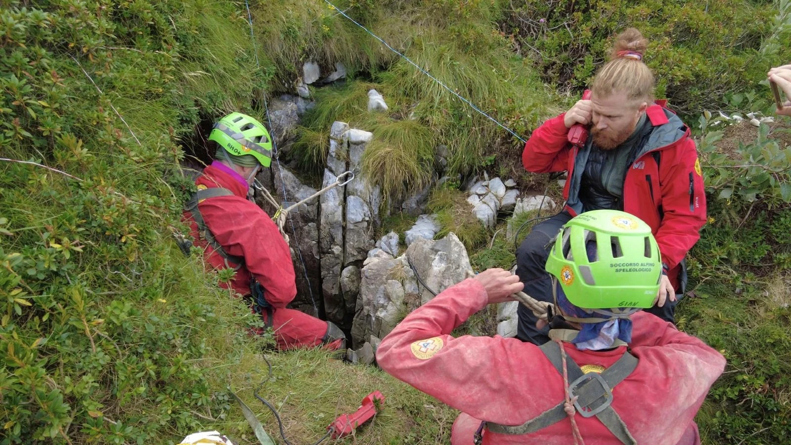 Rescuers work to free an injured cave explorer trapped more than 130 feet underground in Italy