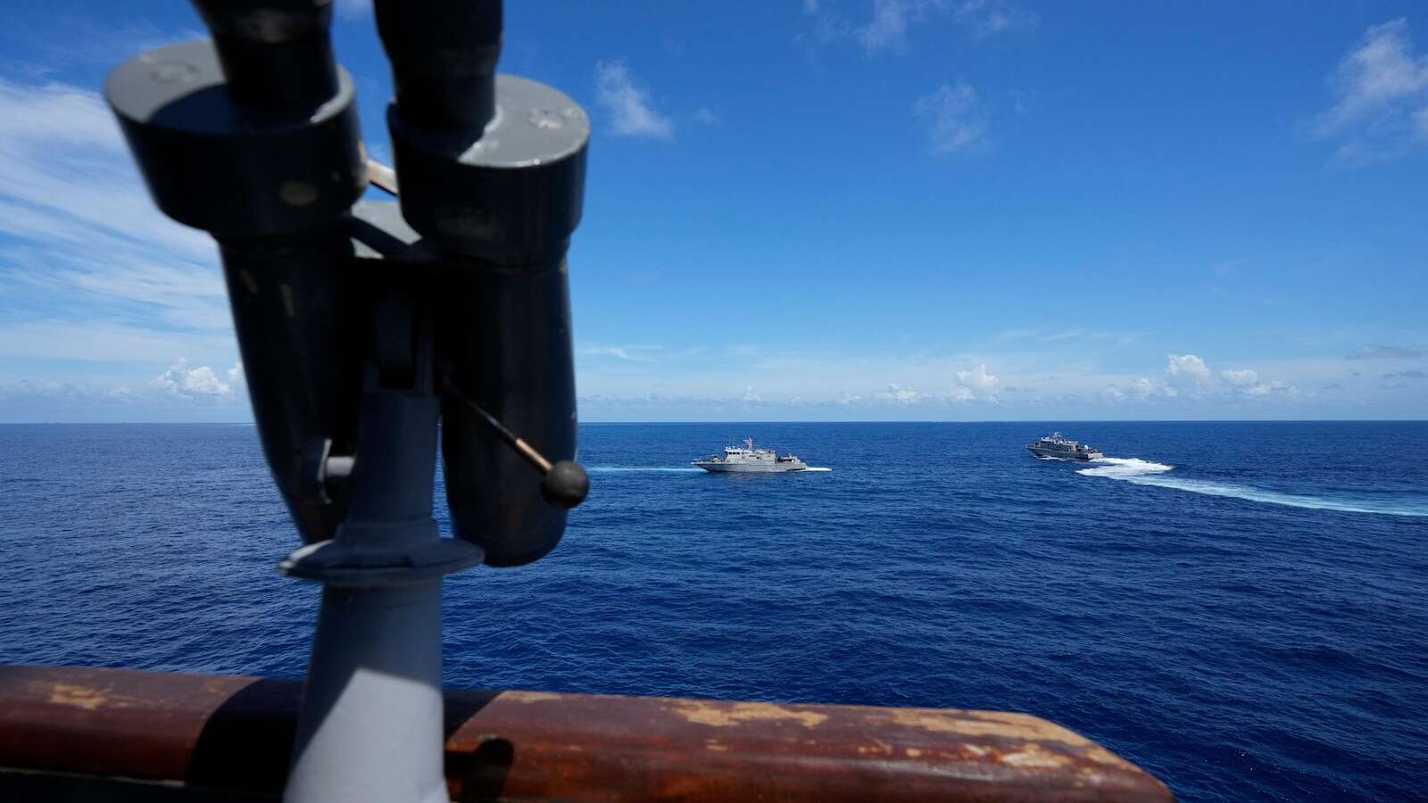 Philippine forces retake an island in mock combat as China's navy watches