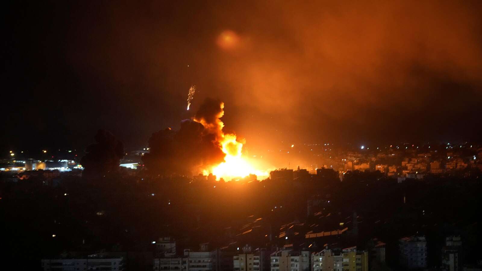 Israeli airstrikes rock southern suburbs of Beirut and cut off a key crossing into Syria