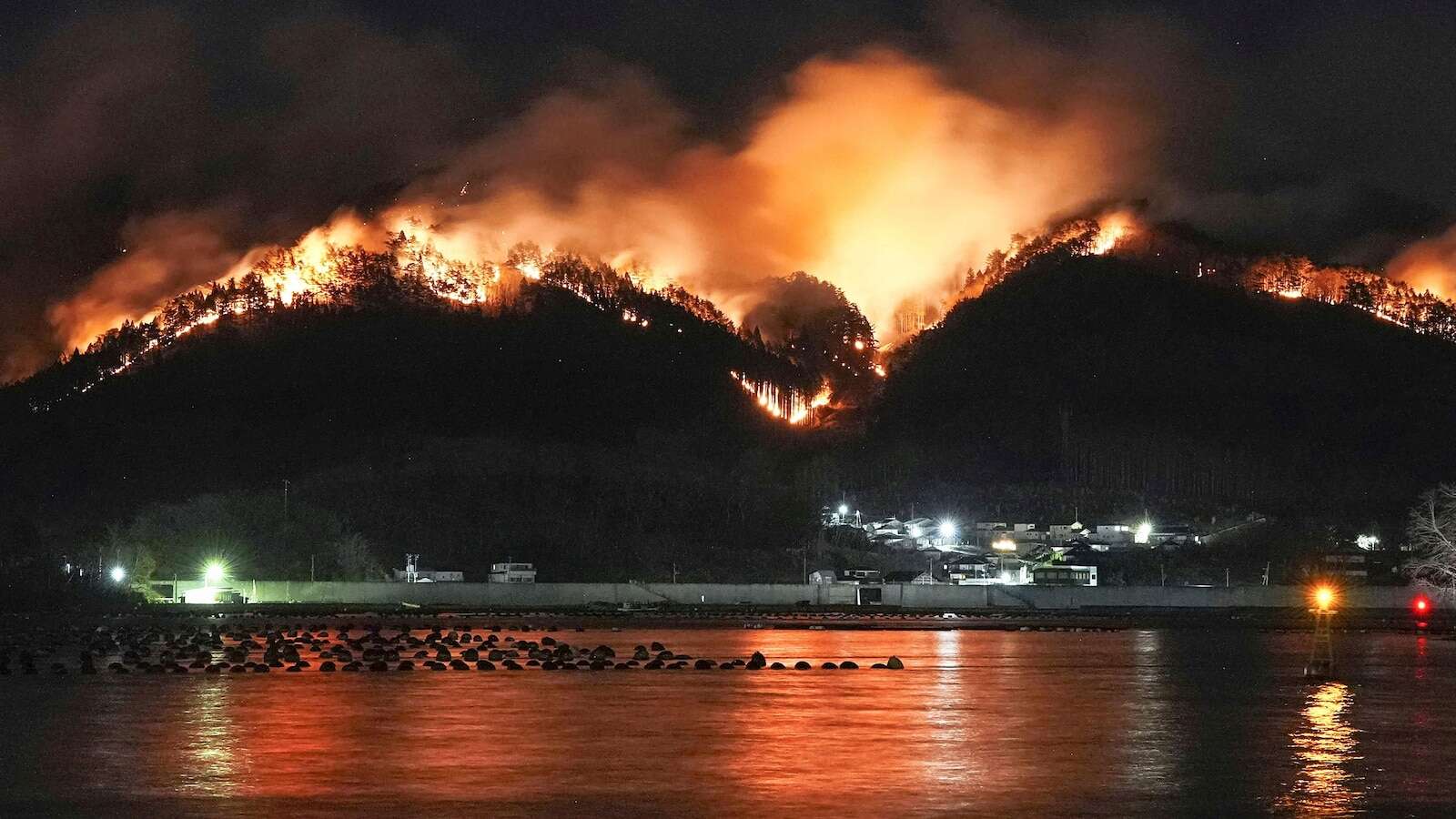 Japan fights forest fire that's damaged dozens of homes, caused hundreds to evacuate