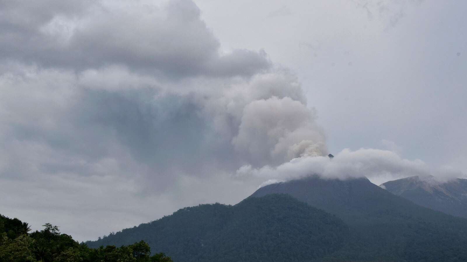 Indonesian rescuers dig through volcanic ash after eruption kills 9 and destroys buildings