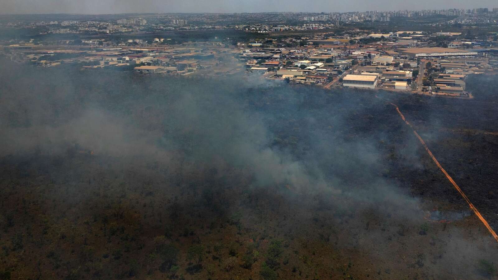 Brazilian firefighters battle national park wildfire that is enveloping Brasilia in smoke