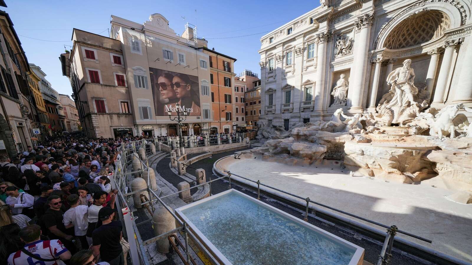 Tourists in Rome now have a walkway to visit the Trevi Fountain but can't toss coins